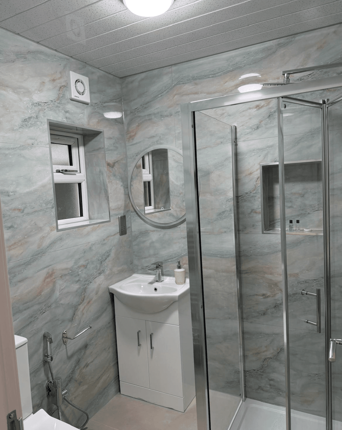 Teal marble bathroom with shower